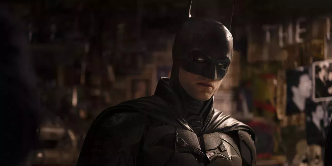 Robert Pattinson as Batman investigating Edward Nashton's apartment in The Batman.