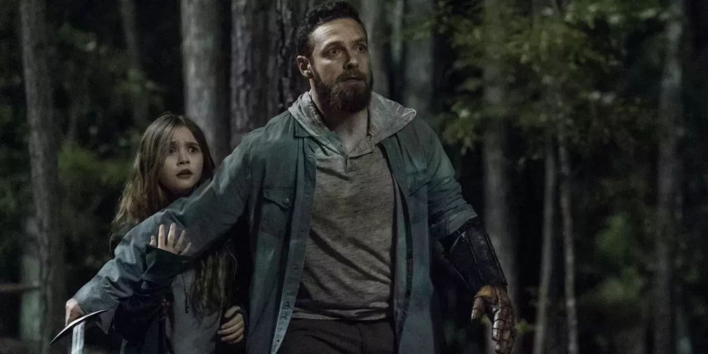 Aaron shielding his daughter Grace in The Walking Dead. 