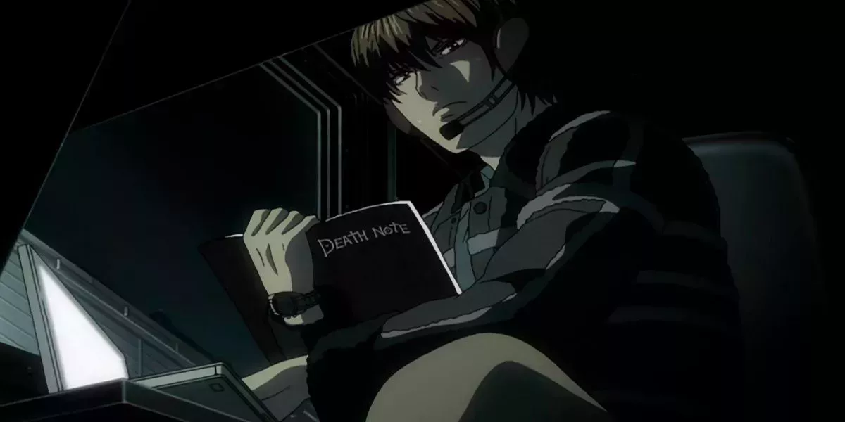 Light in the helicopter holds the Death Note after getting his memories back