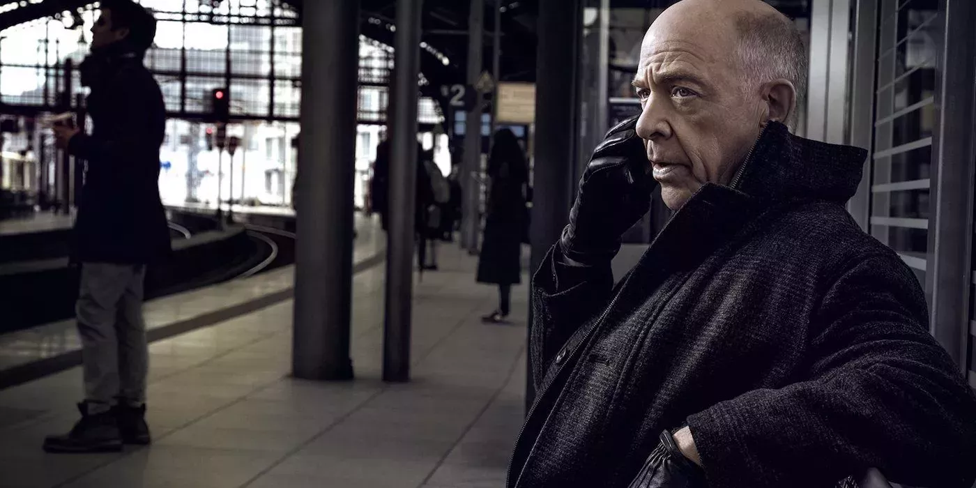 Howard talks on the phone in Counterpart