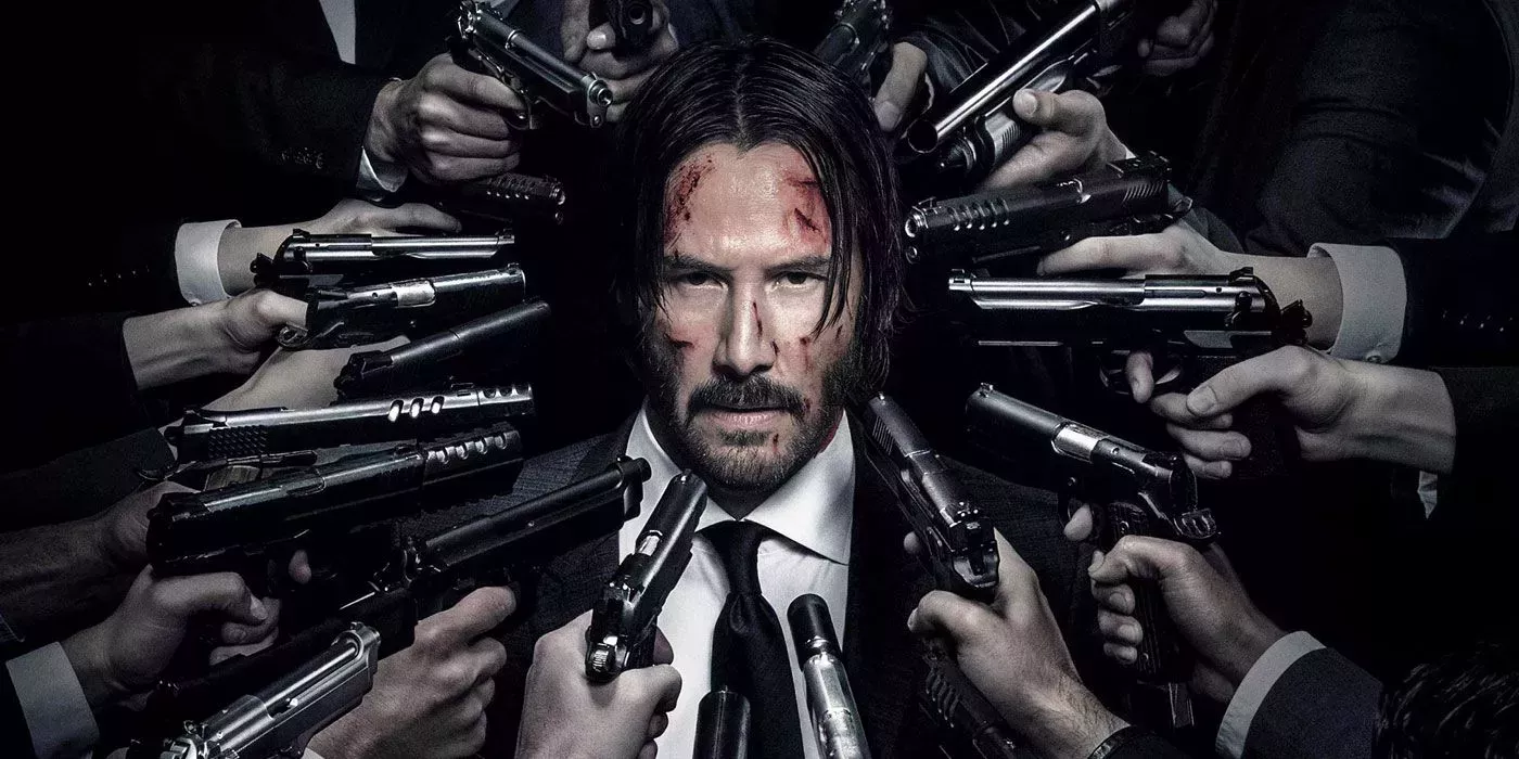 John Wick Chapter 2 Poster with Wick in the middle and a dozen guns pointed at his bloodied face