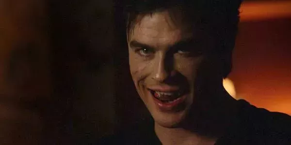 Damon licking his fangs in The Vampire Diaries.