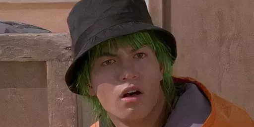 Trip, the Green Power Ranger, looks shocked while wearing a hat in Power Rangers.