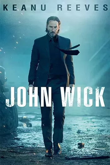 Keanu Reeves as John Wick is walking foward intimidatingly in the poster for the John Wick franchise.