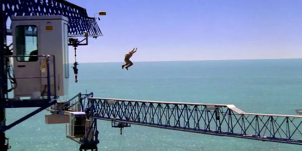 Bond jumps from one part of a crane to another using parkour