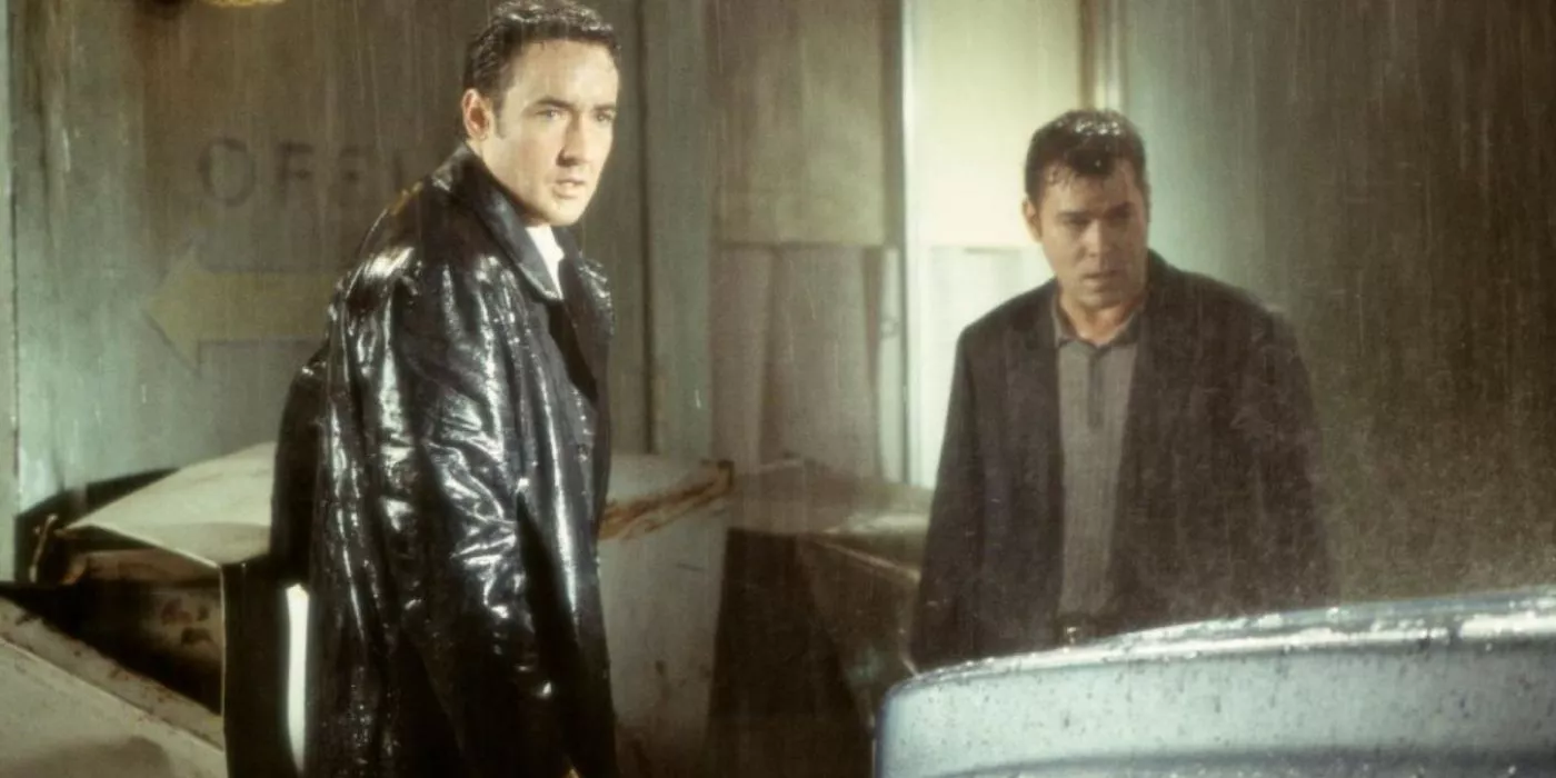 John Cusack and Ray Liotta stand in the pouring rain in Identity