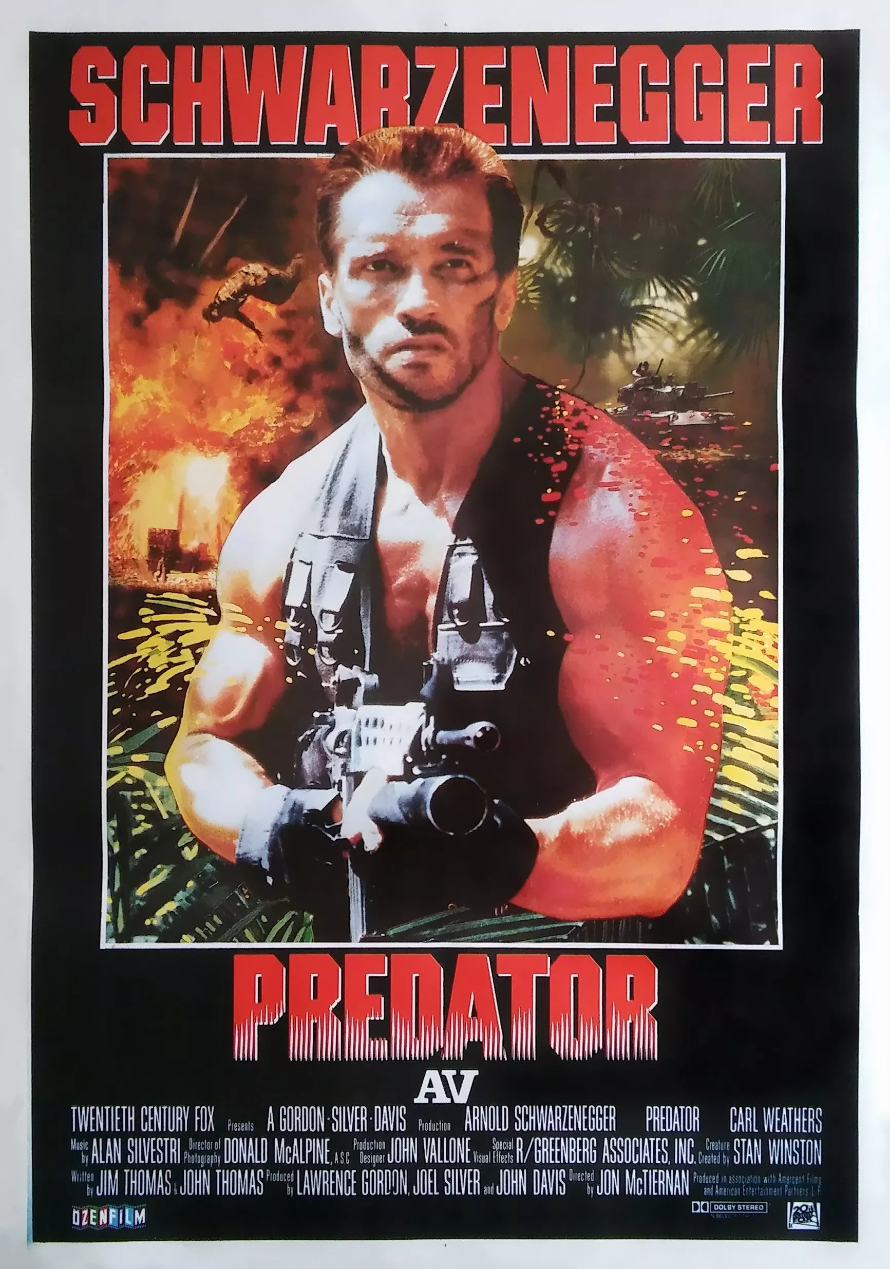 Arnold Schwarzenegger is holding a gun as Dutch on the Predator (1987) film poster.