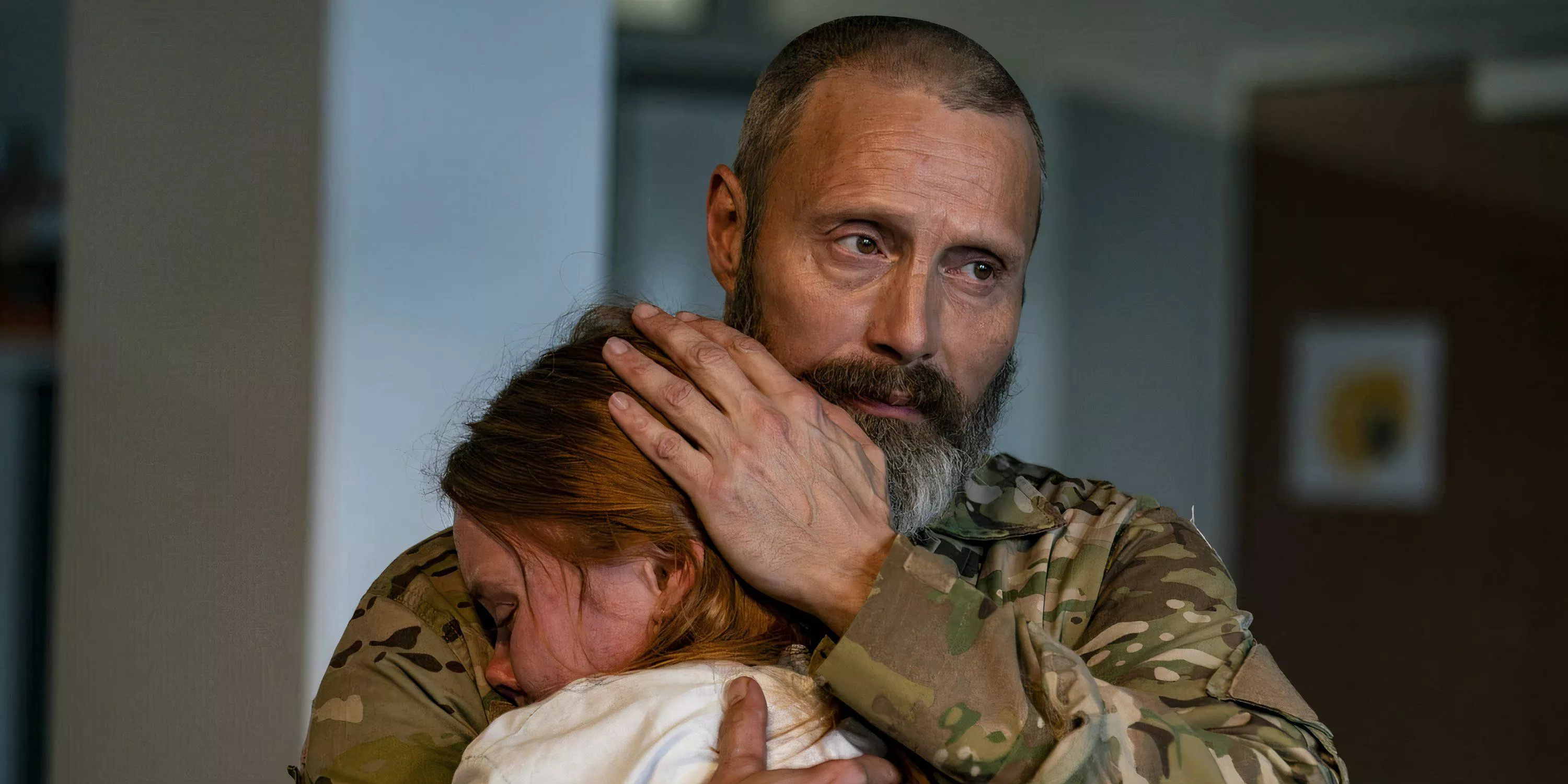 Mads Mikkelson consoles a young girl in Riders of Justice