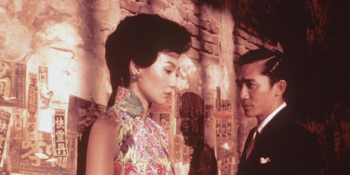 Maggie Cheung and Tony Leung stand against a wall in Wong Kar-wai's In the Mood for Love.