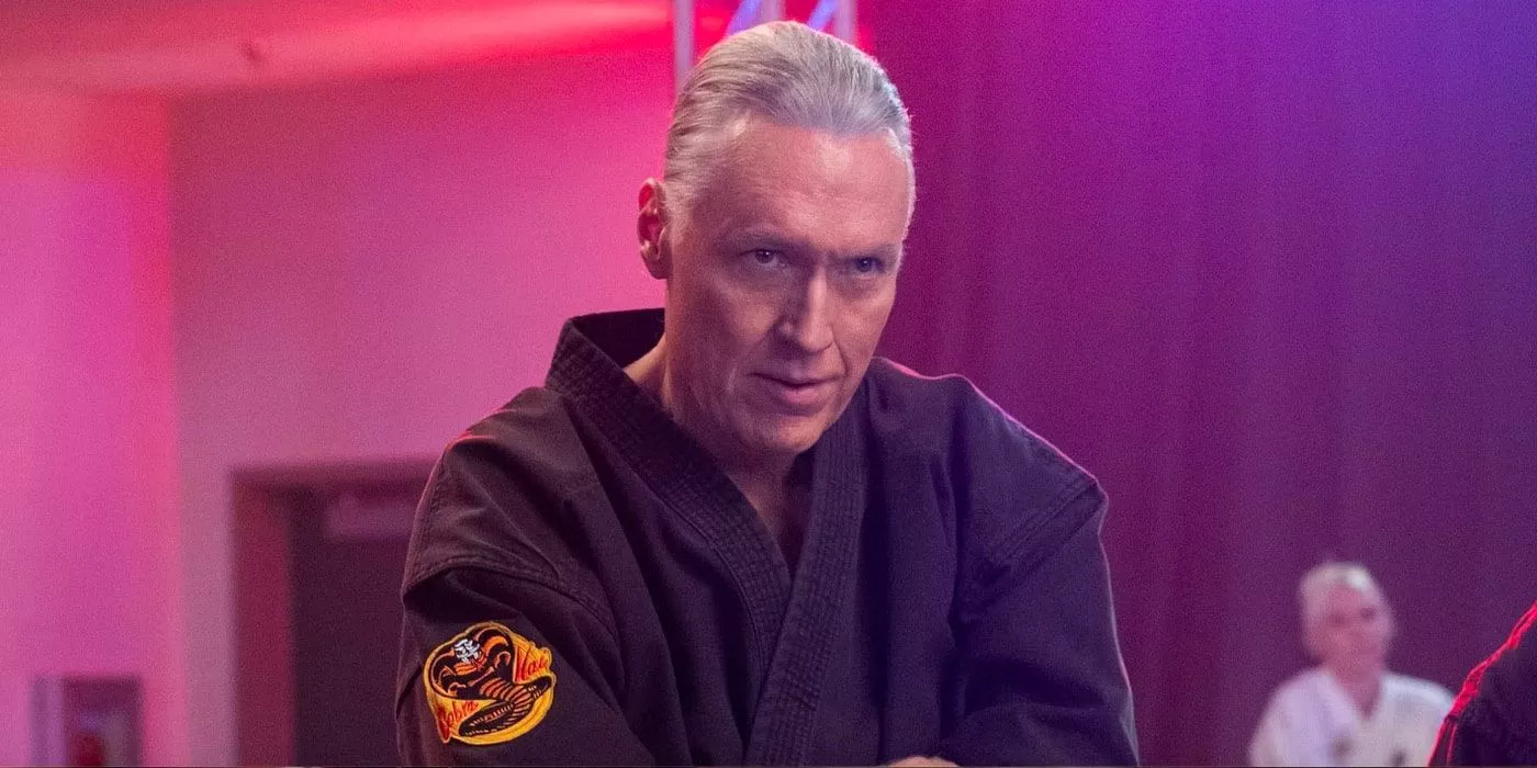 Terry Silver with a menacing face standing in his dojo in Cobra Kai.