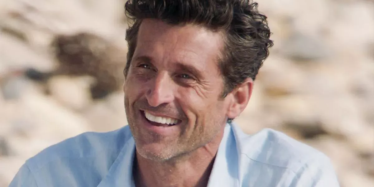 Derek Shepherd (Patrick Dempsey) smiles while wearing a blue shirt in his return to Grey's Anatomy in Season 17