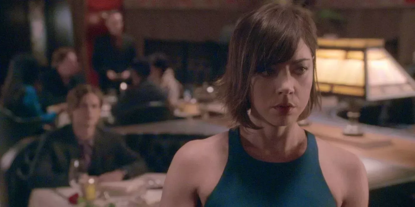 Aubrey Plaza is Cat Adams in Criminal Minds standing at a restaurant with Spencer Reid in the background.