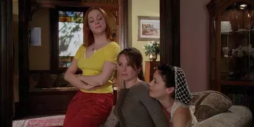 Paige looks smugly at Phoebe and Piper in Charmed season 5