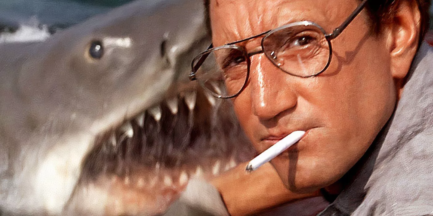 Chief Brody is looking at the camera with a cigarette in his mouth next to the shark in Jaws