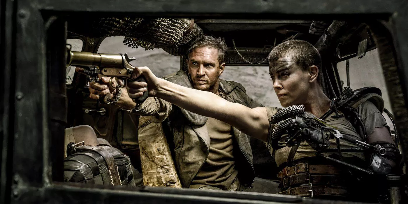 Tom Hardy as Mad Max and Charlize Theron as Furiosa fighting back against scavengers in the Pass in Mad Max: Fury Road.