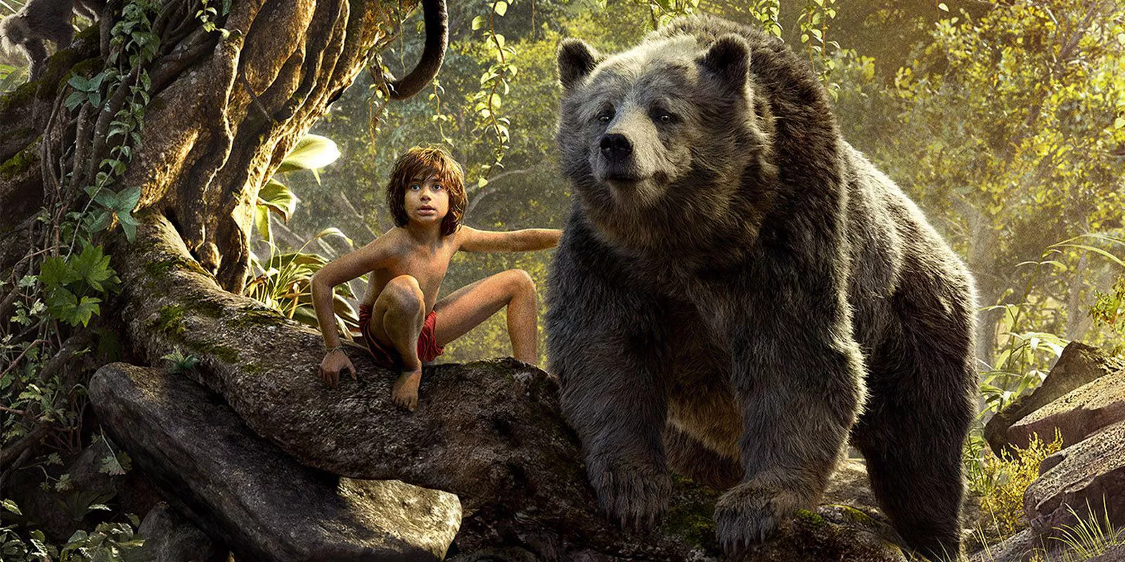 Mowgli and Baloo on a tree branch in The Jungle Book 2016