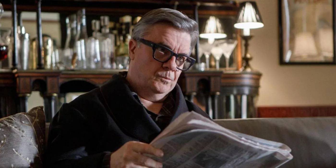 Teddy (Nathan Lane) reads a newspaper in Only Murders in the Building