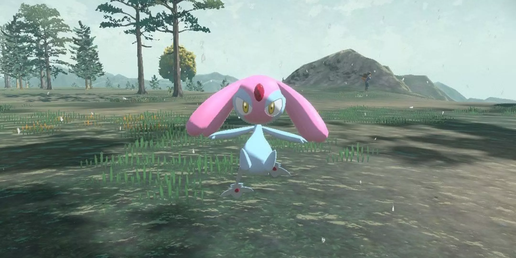 Mesprit flotando sobre el suelo en el área del Monte Coronet de Pokémon Legends Arceus