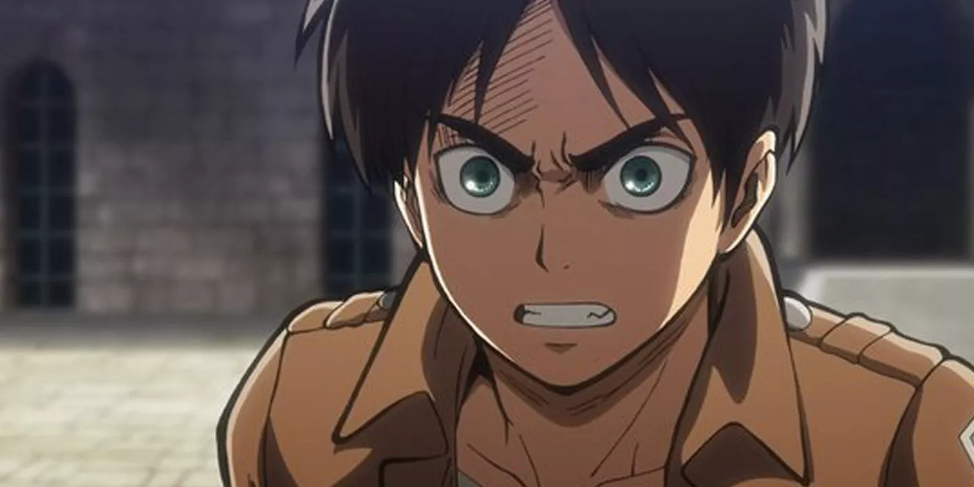 An angry Eren glares on a street in Attack on Titan.