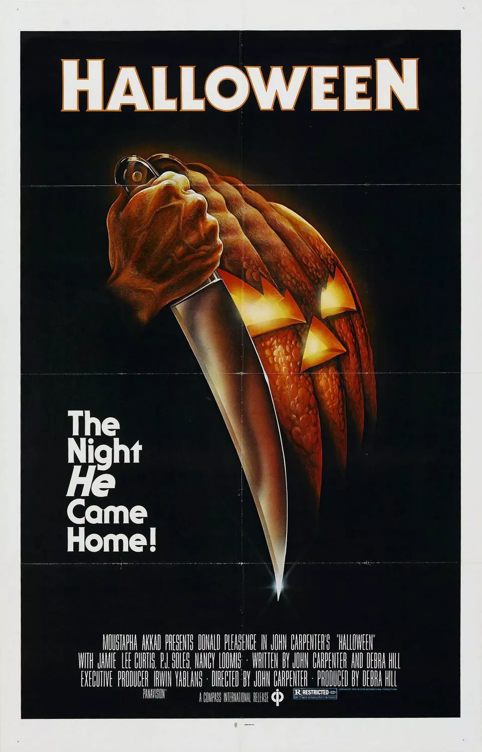 The Halloween movie poster depicts a hand holding a knife next to a scary jack-o'-lantern.