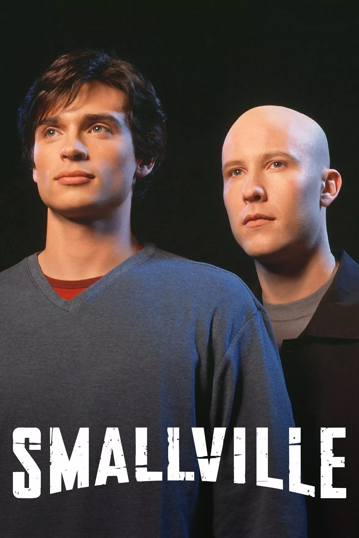 The Smallville poster depicts Tom Welling's Clark Kent and Michael Rosenbaum's Lex Luthor staring into the distance.