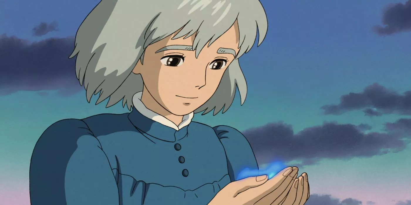 Sophie Hatter smiling down at Calcifer in her hands in Howl's Moving Castle.