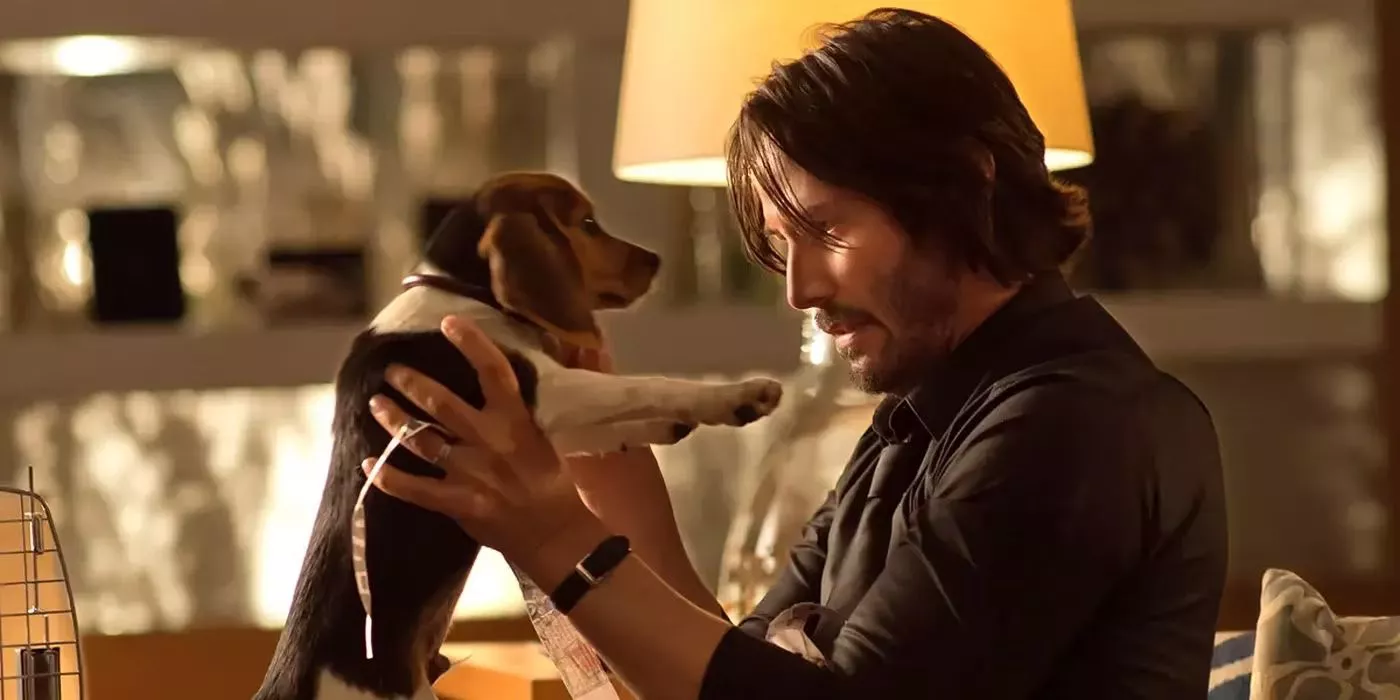 John Wick (Keanu Reeves) holds a puppy in the first John Wick movie.