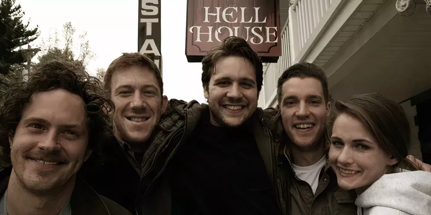 A group of friends is posing in front of Hell House LLC