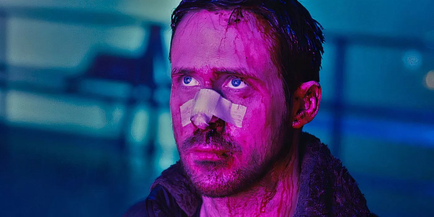 K is standing in a neon-colored area with a bandage on his nose in Blade Runner 2049