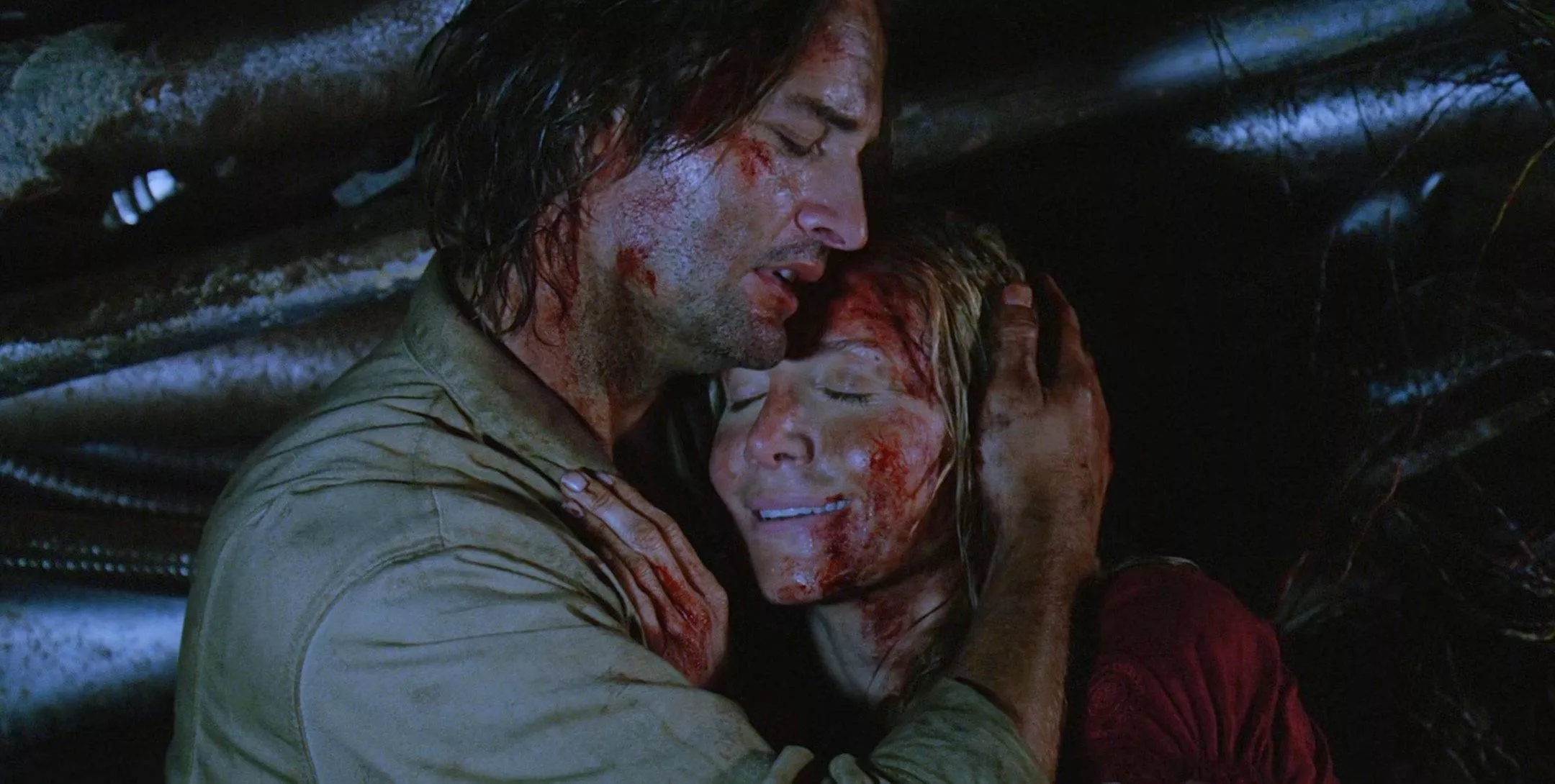 a bloody James Sawyer Ford holds an equally bloody Juliet Burke, eyes closed, smiling, as she dies amid wreckage in the lost series