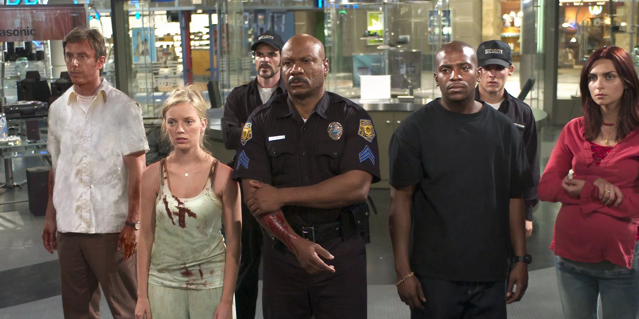 The survivors are standing together inside the mall in Dawn of the Dead 2004