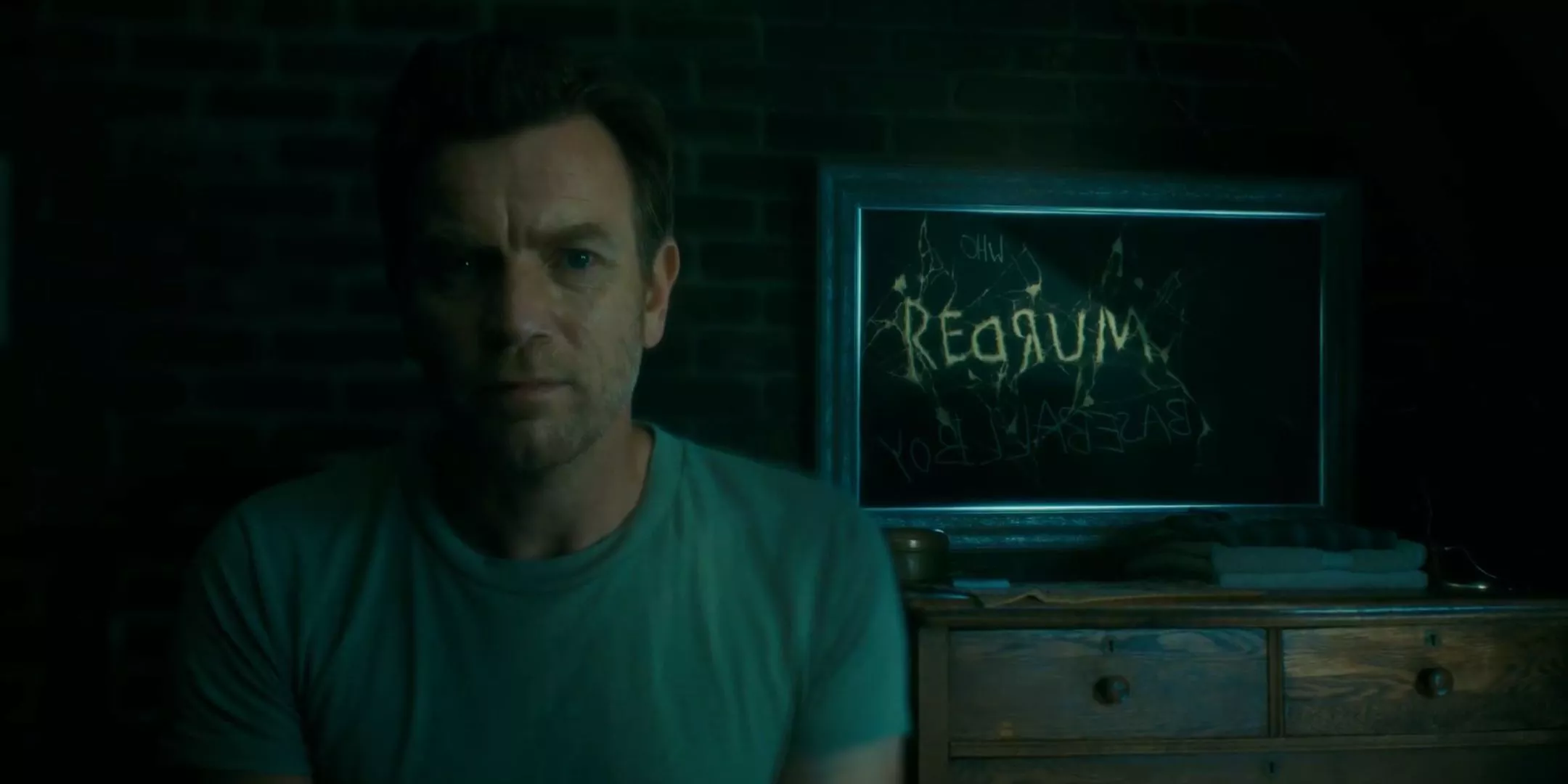 Ewan McGregor as Dan Torrance looks at a mirror refelecting REDRUM and actually saying murder in Doctor Sleep