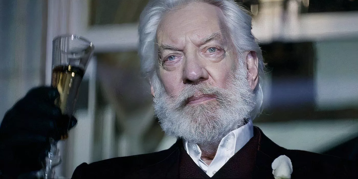 President Snow raising a glass of champagne in The Hunger Games: Catching Fire.