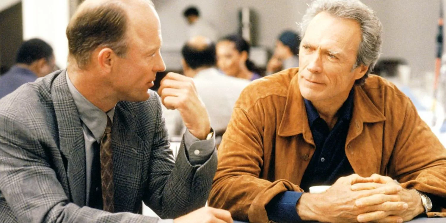 Ed Harris and Clint Eastwood sitting at a table in Absolute Power