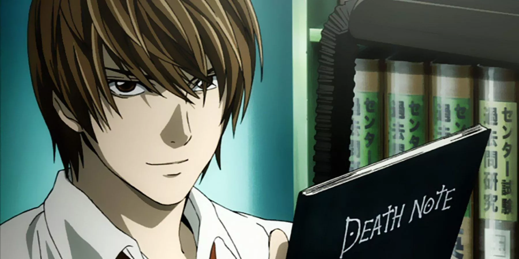 Light Yagami holds up the death note.