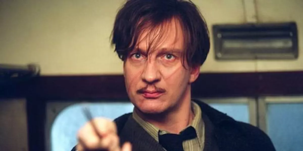 Remus Lupin points his wand at a Dementor on the Hogwarts Express in Harry Potter.