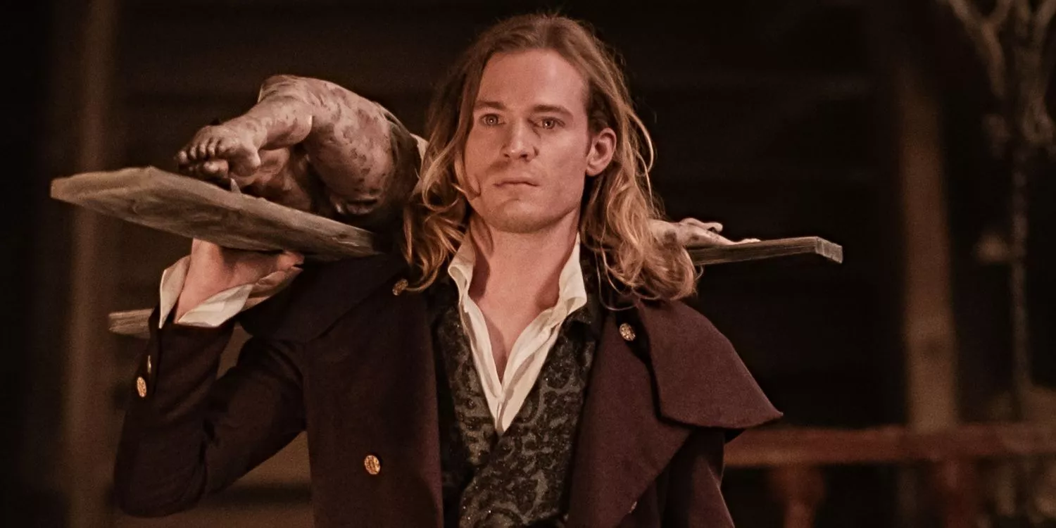 Sam Reid as Lestat holds a crucifix in Interview with the Vampire.