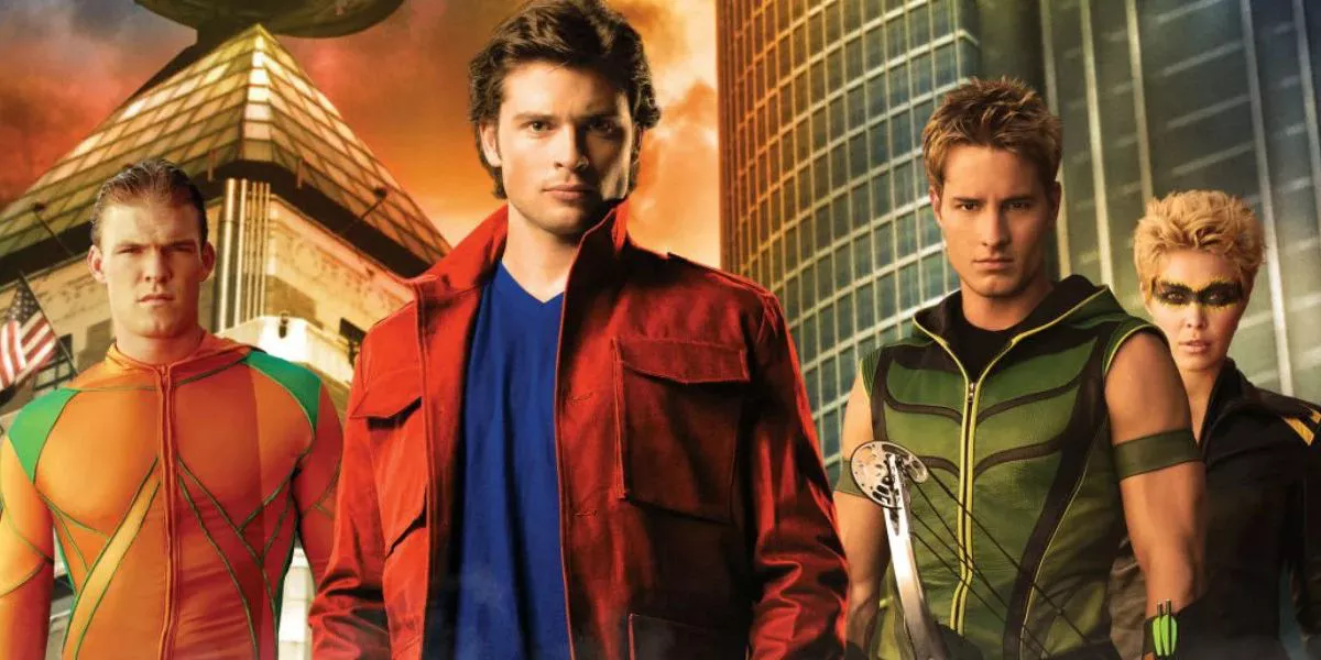 Smallville's Clark Kent (Tom Welling) is standing next to other members of the Justice League, including Aquaman (Alan Ritchson) and Green Arrow (Justin Hartley).