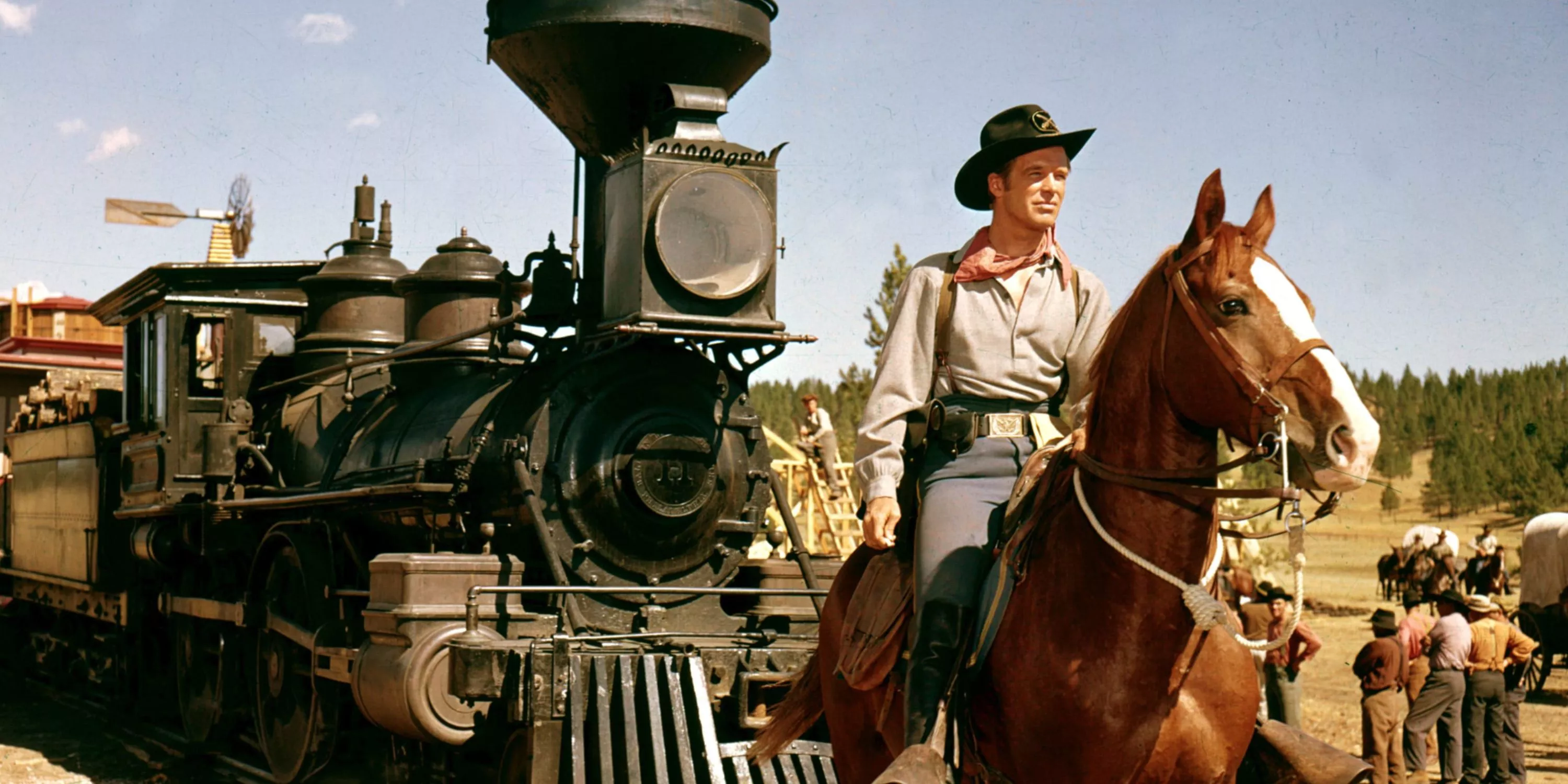 Man on horseback in front of a train