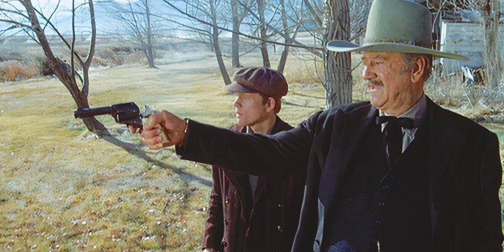 John Wayne teaches Ron Howard how aim and fire a weapon in The Shootist.