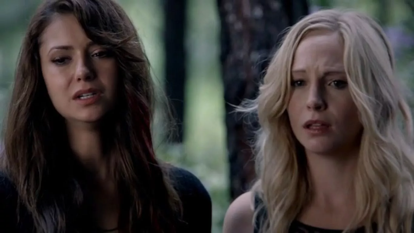 Elena and Caroline stand next to each other in The Vampire Diaries.