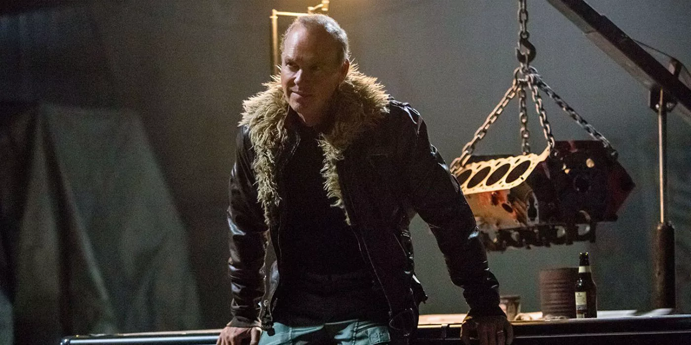 Michael Keaton as Adrian Toomes leaning against a workbench in Spider-Man: Homecoming.