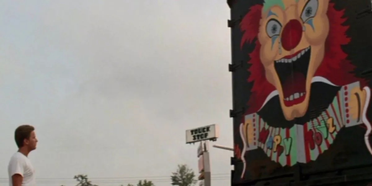 Emilio Estevez looks at the back of the truck, featuring a crying clown, in Maximum Overdrive