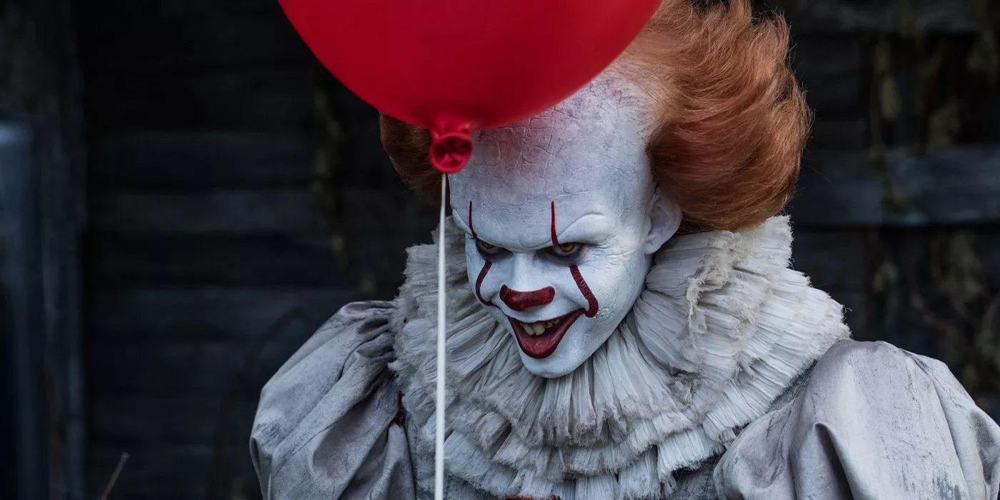 Pennywise is grinning in the two-part film adaptation of Stephen King's It.