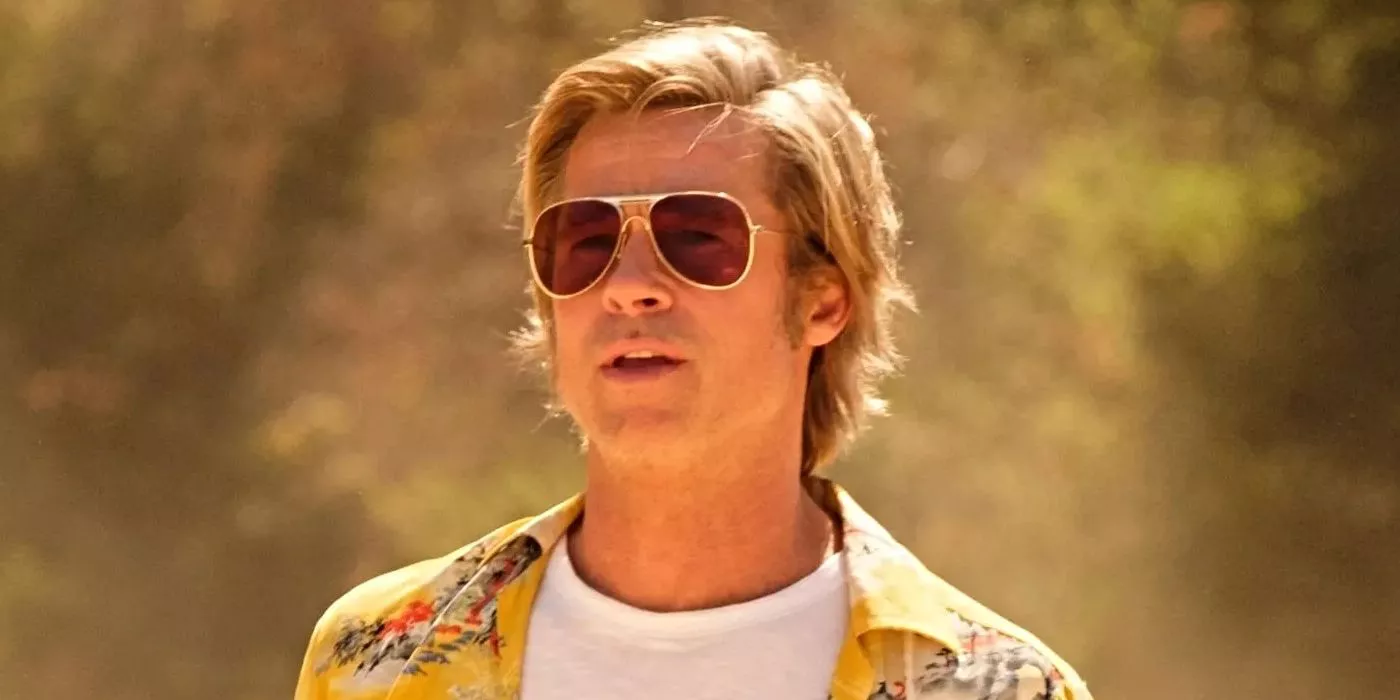 Brad Pitt is in a white t-shirt under a Hawaiian shirt in Once Upon a Time in Hollywood.