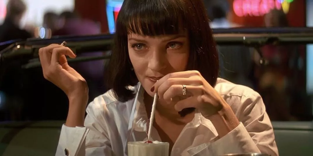 Mia Wallace drinks a milkshake in Pulp Fiction.